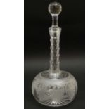 A 19thC glass decanter with facet cut decoration to the long neck and etched decoration to body.