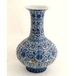 A Chinese Blue and white flared rim bottle vase of ridged form , decorated with scrolling