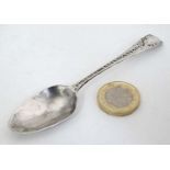 A Geo III silver teaspoon with bright cut decoration to handle.