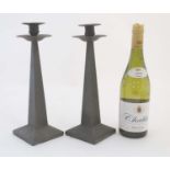 Decorative Metalware : A pair of pewter candlesticks of squared tapering form with plannished