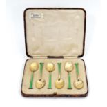 A cased set of 6 silver gilt teaspoons with guilloché enamel decoration to handles. Hallmarked