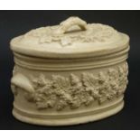 A late 19thC salt-glazed small stoneware lidded tureen in cream, decorated with fruiting vines.