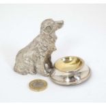 A novelty table salt formed as a seated Golden retriever type dog before a bowl.