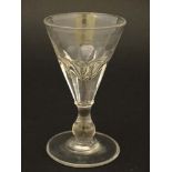 A 19thC trumpet formed pedestal glass with facet cut sides and clear glass foot with ground pontil