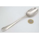 A Geo II HM silver tablespoon with shell decoration to back of bowl.