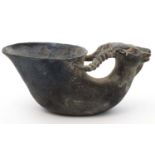 A bronze Chinese libation cup with goat / rams head handle, bears Chinese 4 character mark to base.