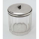 A glass dressing table pot with slice cut decoration and silver lid hallmarked Birmingham 1910