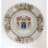 A Chinese Export Armorial plate , decorated to central well with the ,