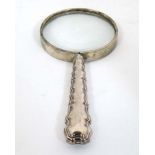 A silver handled magnifying glass.