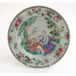 A Chinese Famille Rose plate decorated with Renaissance style figures in a garden scene to central