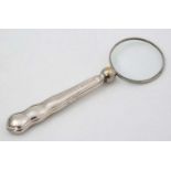 A silver handled magnifying glass.