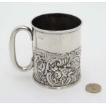 A silver Christening mug / tankard with acanthus, C-scroll, dolphin floral and mask decoration.