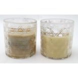 A pair of large cut glass candle holders. Each 5'' high.