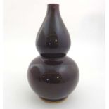 A Chinese Sang De Beouf double gourd vase , having unglazed base. 16'' high.