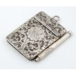 A silver aide de memoir / miniature notebook with silver case having acanthus scroll decoration and