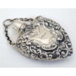 A heart shaped scent / perfume bottle on chain. Marked Sterling .