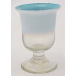 A blue and white vaseline glass drinking glass of pedestal form on circular foot.