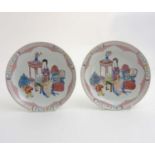 A Chinese pair of hand painted Famille Rose plates decorated in polychrome enamels,