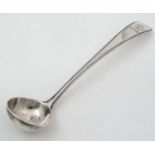 A Geo III silver salt ladle with beaded decoration and armorial to handle.