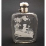 A glass hip flask with Mary Gregory style decoration to one side.