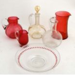 Assorted glassware to include various Cranberry glass jugs, carafes and short comport.