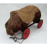 Toy: A 19th / early 20thC pull along bear, straw filled on metal base,