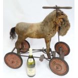 Toy: A late 19th / early 20thC pedal operated ride on Steiff horse, straw filled on metal base,