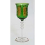 An early - mid 20thC facet cut green glass wine glasses with gilded rim,