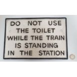 21stC painted cast metal sign 'Do Not Use The Toilet While The Train Is In The Station',