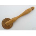 Kitchenalia : an old wooden pastry cutter of wheel and shaft form,