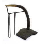A cast bronze desk calendar in the form of an African Deer antler with hanging sections for