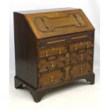 A late 18thC/early 19thC oak bureau with geometric moulding to the front,