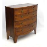 An early 19thC mahogany bow fronted chest of drawers comprising two short over three long drawers