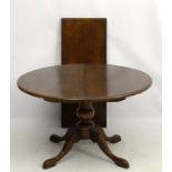 A 20thC oak oval drop flap extending pedestal table 47 1/2" wide x 67 1/2" extended