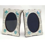 A pair of silver photograph frames with enamel floral decoration in the Art Nouveau style. Maker RH.