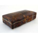 A 19thC tortoiseshell box of cupids bow shape with velvet lining on squat bun feet.