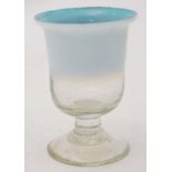 A blue and white vaseline glass drinking glass of pedestal form on circular foot.