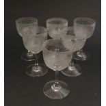 A set of 6 late 19thC / eary 20thC pedestal wine glasses with decoration to bowl depicting bird on