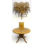 A set of 6 elm seated stick back Windsor chairs with cowhorn stretchers together with an extending