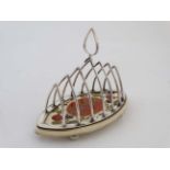 An early 20thC Taylor and Tuncliffe toast rack with ceramic base,