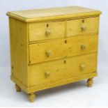 A 19thC stripped pine chest of drawers comrpsing 2 short over 2 graduate long drawers on turned