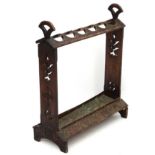 An unusual Edwardian carved oak 6-division stick stand with copper tray.