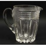 A heavy cut glass jug with loop handle 7" high CONDITION: Please Note - we do not