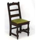 A 17thc style naively carved oak hall chair with upholstered seat 38" high CONDITION: