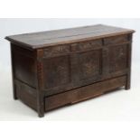 A 17thC and later three panel oak mule chest with coffer section opening to reveal candle box and