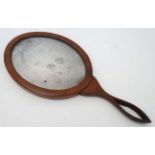 An 18th / 19thC mahogany hand mirror with oval old glass.