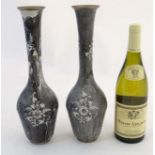 A pair of Continental drip enamel decorated turned metal bottle vases.