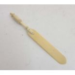 An Edwardian carved ivory paperknife with turned and fluted handle , 6 3/4” long.