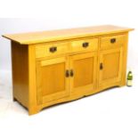 A 21stC golden oak serving cabinet / low dresser with 3 drawers and three cupboards.