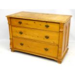 A 19thC Continental pine chest of drawers having carved scrolling corbels flanking the drawers,